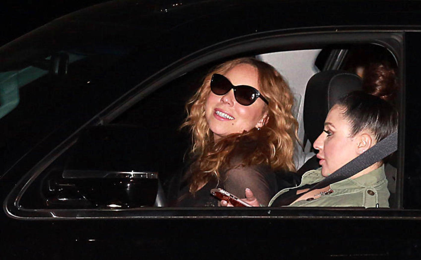Mariah Carey blows a kiss for the cameras as she leaves Nobu in Malibu with a friend
